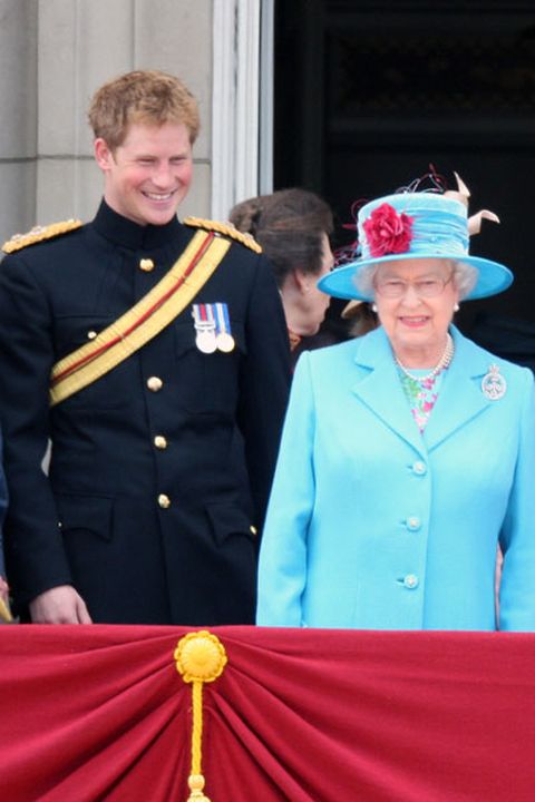 Prince Harry, Laughs next to HM Queen Elizabeth II as they look out from the balcony of Buckingham Palace after the Trooping the Colour ceremony on Ju