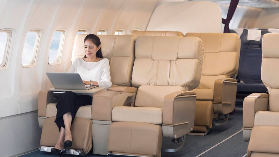 Elegant mature Chinese woman using laptop on airplane Beijing China Copyright: xLianxFeix bji05460158
