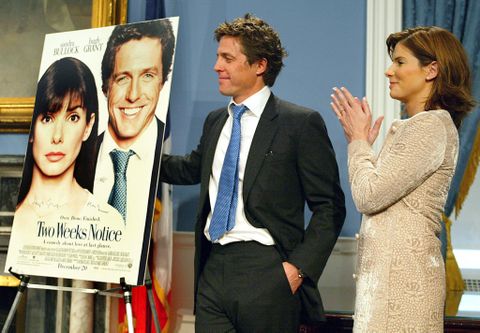 Two Weeks Notice&quot; stars Sandra Bullock (R) and Hugh Grant clap as they are welcomed to City Hall 11 December, 2002 by Mayor Michael Bloomberg to 