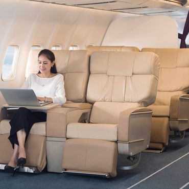 Elegant mature Chinese woman using laptop on airplane Beijing China Copyright: xLianxFeix bji05460158